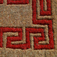 Eco-friendly MyMats coir doormat in red and beige placed at the main door—suitable for outdoor or indoor entrances.