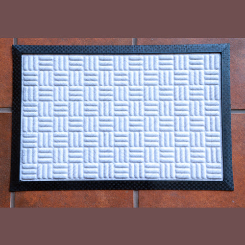 Eco-friendly mymats doormat in white polypropylene with textured surface for dust trapping and non-slip rubber backing.