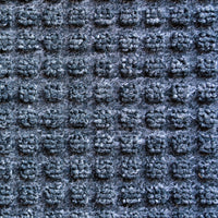 Stylish blue surface mat with heavy-duty black rubber base, perfect for entrances